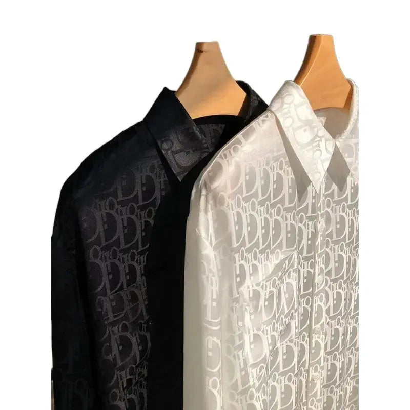 Black and white patterned fabric on wooden hangers against a white background