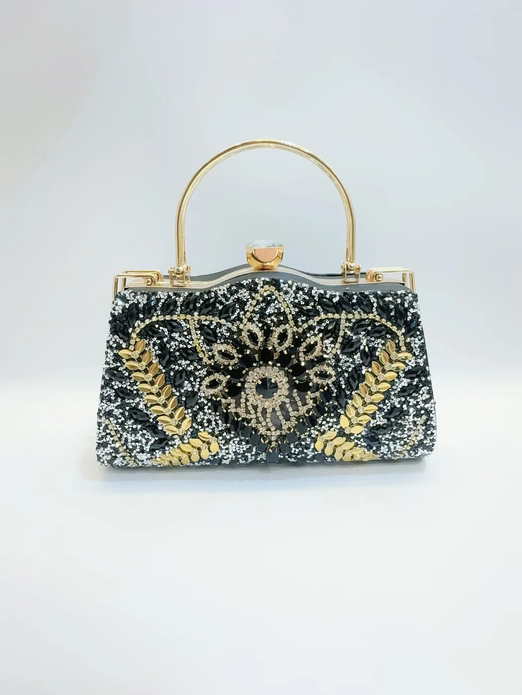 Black handbag with gold accents on a white background