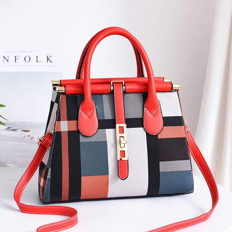 women's handbag Colorful checkered handbag with red handles and strap on a light background