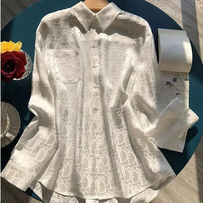 White shirt with lace detailing on a dark surface with decorative items.