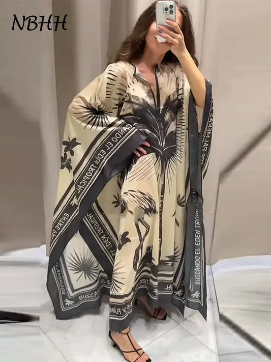 Person wearing a patterned scarf with text and palm tree design, standing against a neutral background.