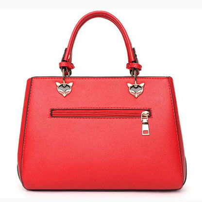Women's Handbag Red handbag with silver heart-shaped charms on a white background