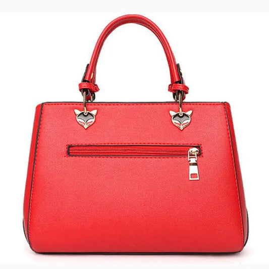 Women's Handbag Red handbag with silver heart-shaped charms on a white background