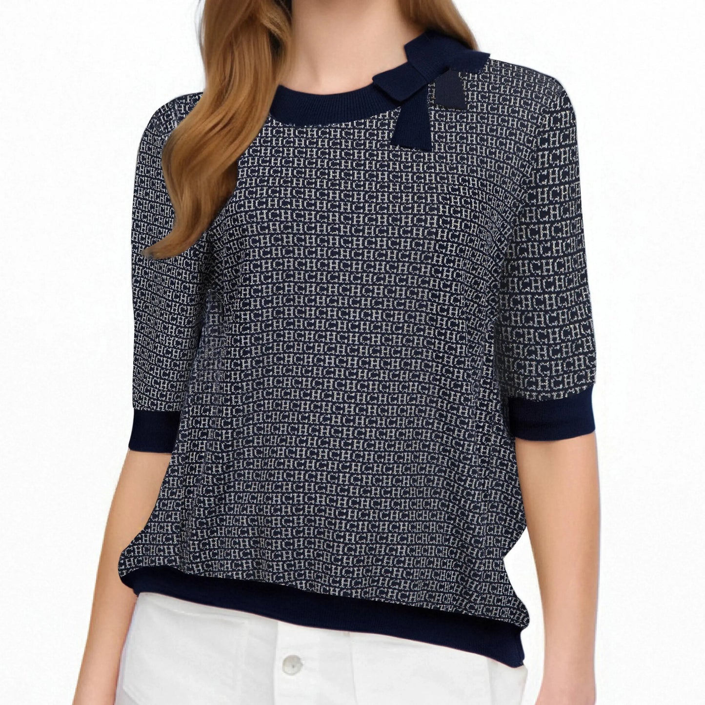 Person wearing a patterned sweater with navy accents on a white background